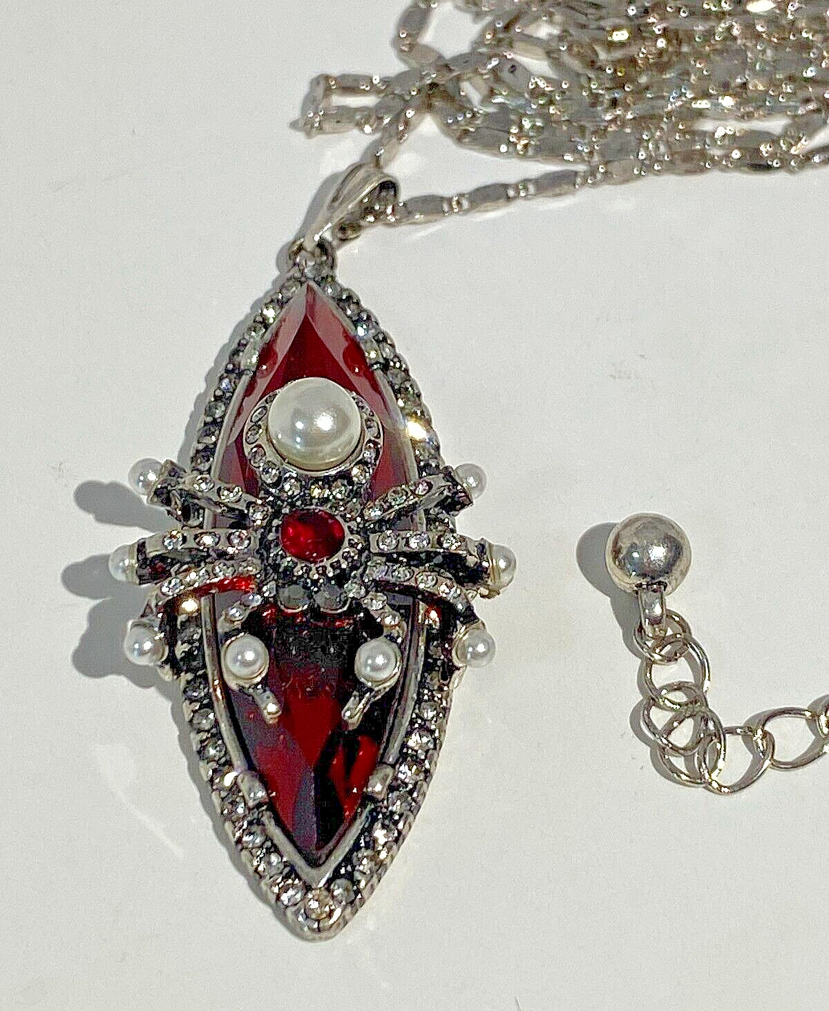 UNIQUE SPIDER SILVER PENDANT SITTING ON RED LUCITE WITH PEARLS & CRYSTALS
