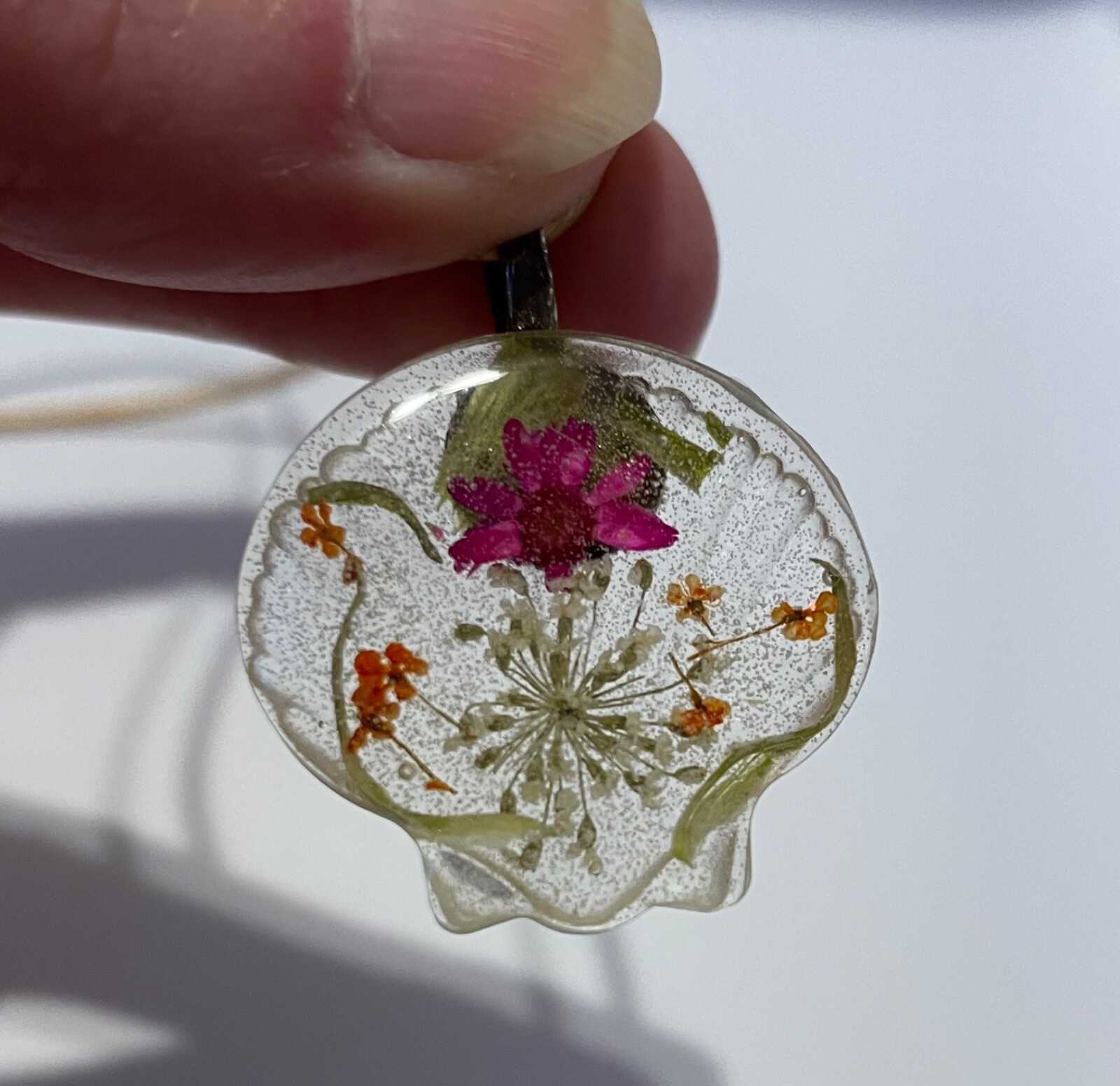 hand crafted by me resin sea shell shaped necklace, real dried flowers inside