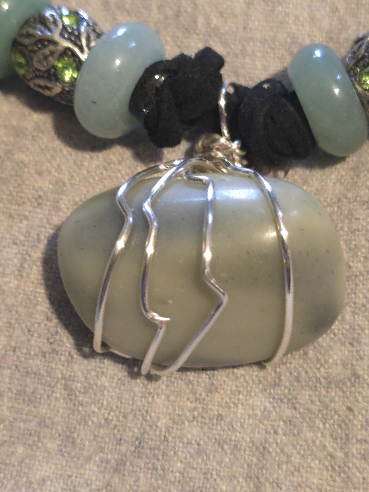 Infinite Stone Pendant On A Black Hand Braided Leather Necklace.
