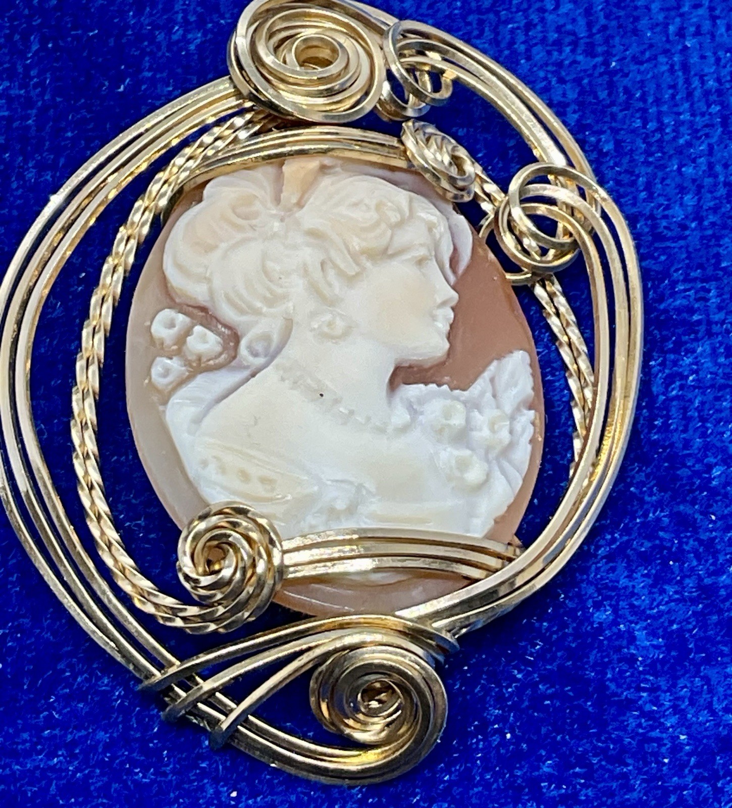 A Hand Carved Shell Cameo Pendant Wire Wrapped In Gold Filled Wire.