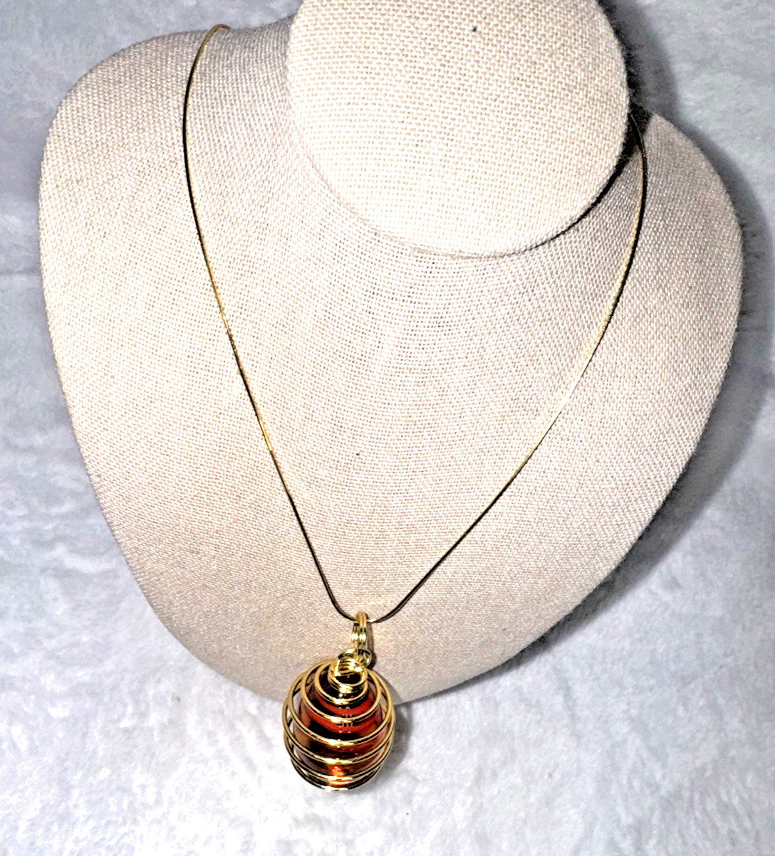 Handmade, glass, Christmas Red egg in gold colored wire cage.