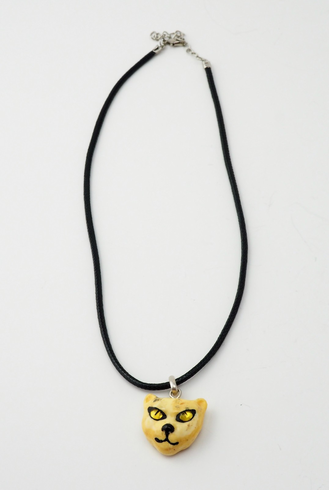 Unique Artisan butterscotch amber carved cat face pendant black chord necklace