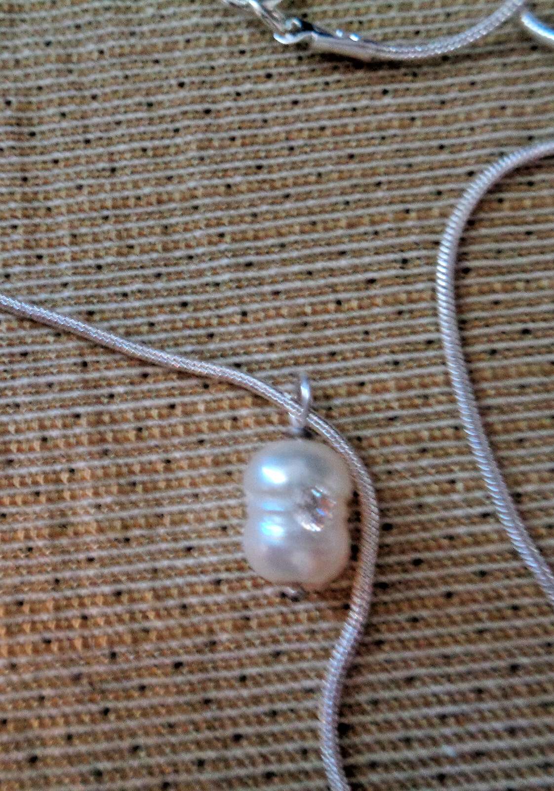 Handcrafted 6×9 mm, white freshwater pearl pendant, set with cubic zirconium on