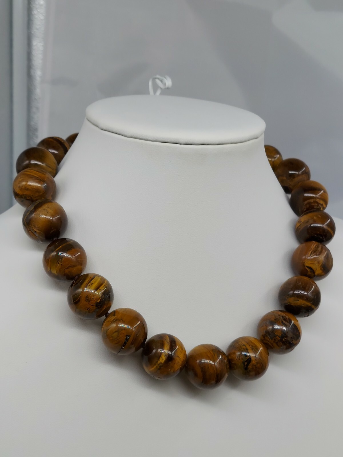 NATURAL TIGER EYE, 15:MM ROUND STONES, 17″ LONG NECKLACE, WITH A DESIGNED CLASP.