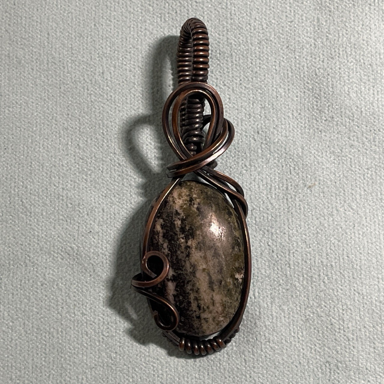 Handcrafted copper wire-wrapped pendant oval-shaped Picture Jasper stone