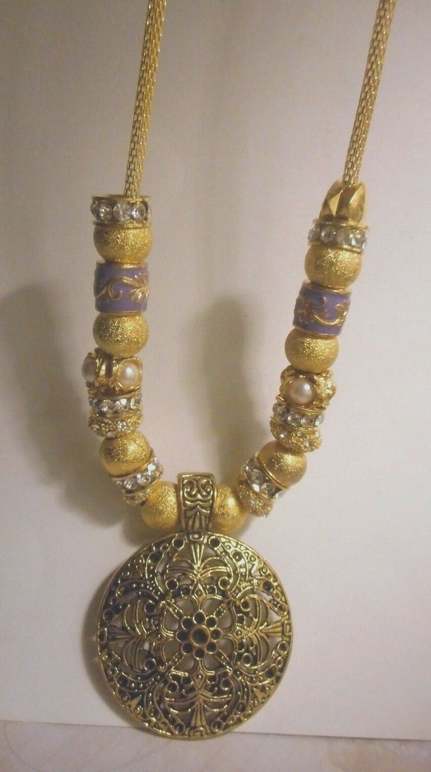 Beautiful one of a kind hand assembled necklace with gold tone beads & charms