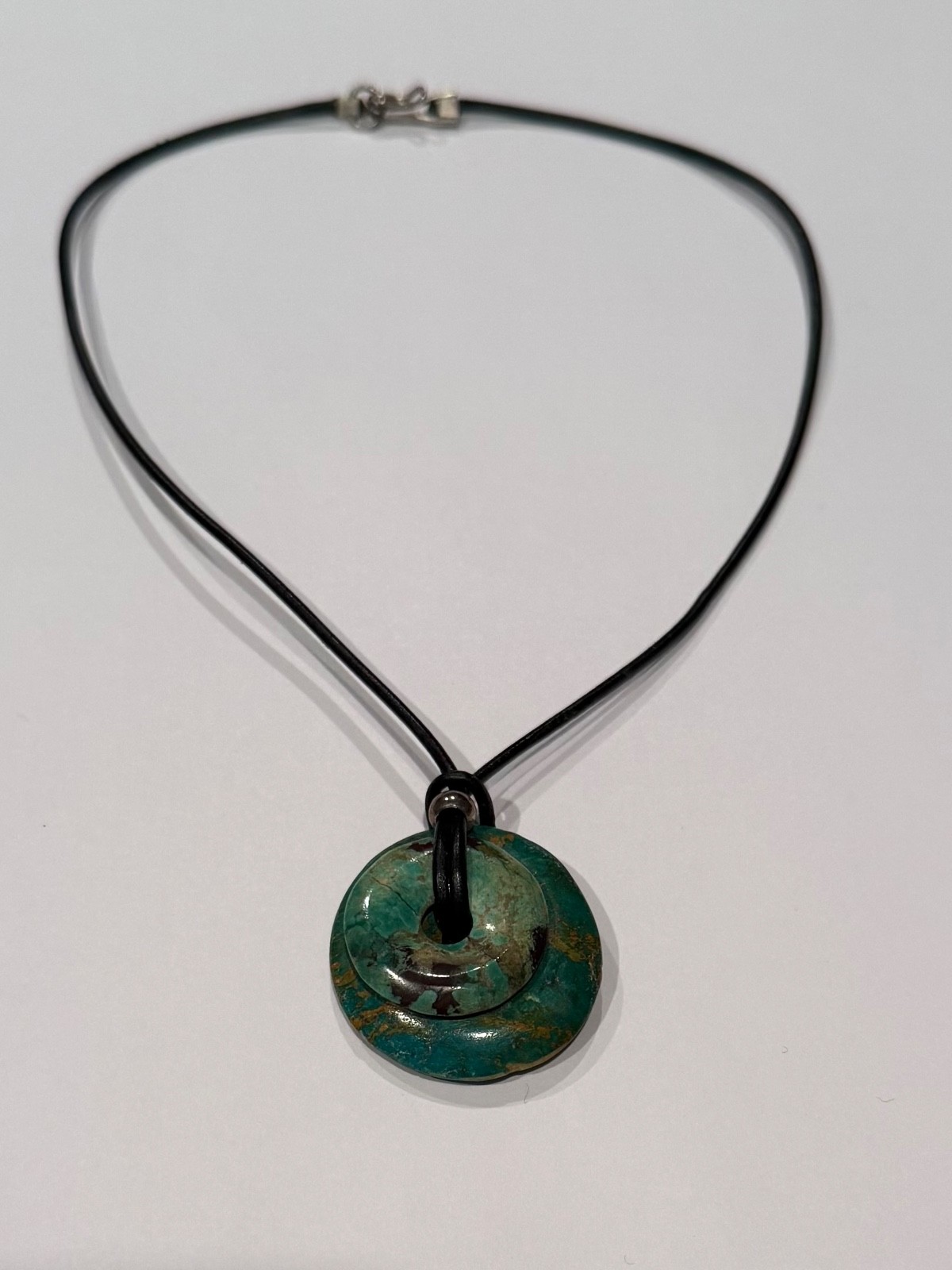 Two handmade turquoise stone necklaces on black leather strand