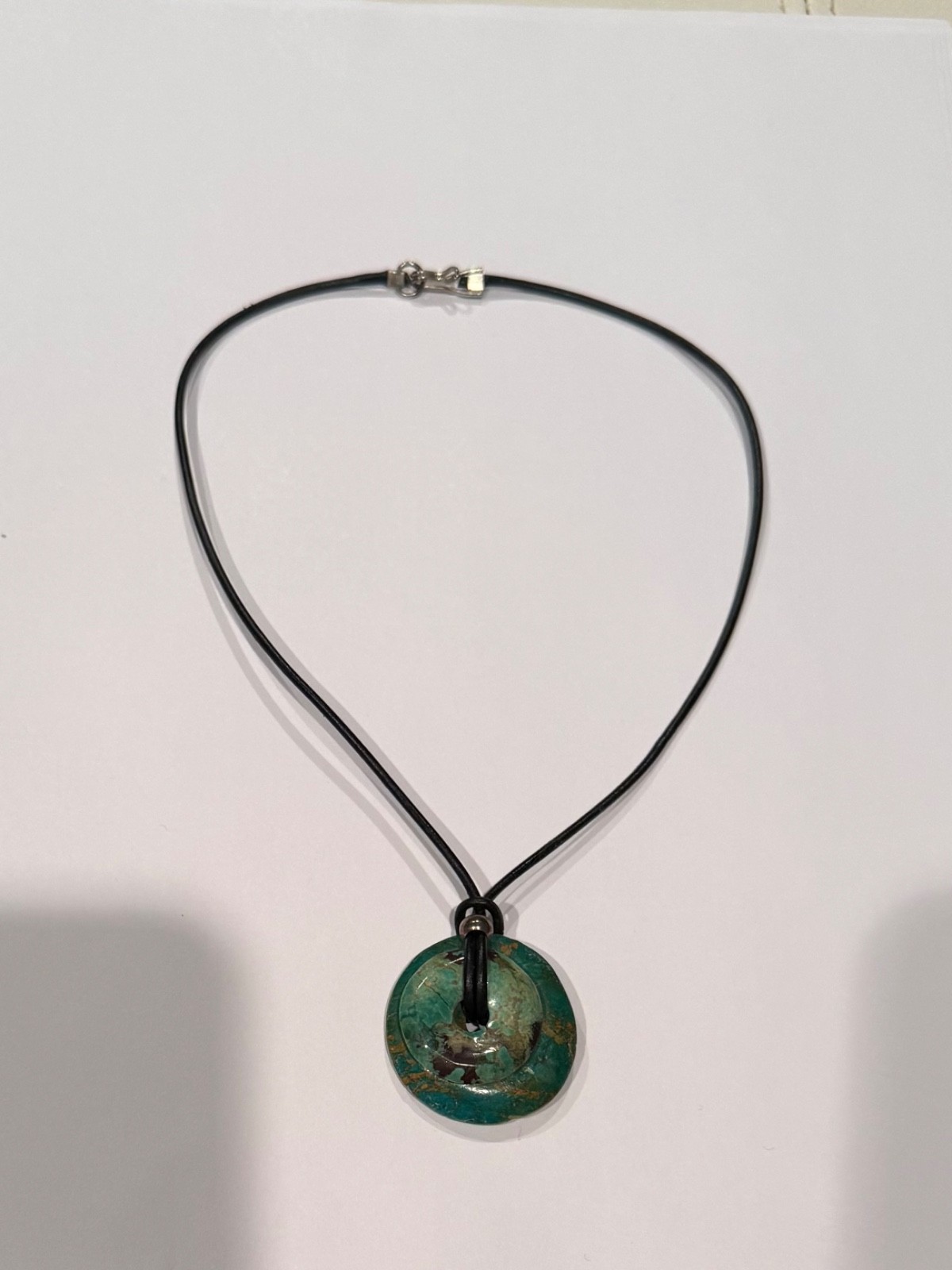 Two handmade turquoise stone necklaces on black leather strand