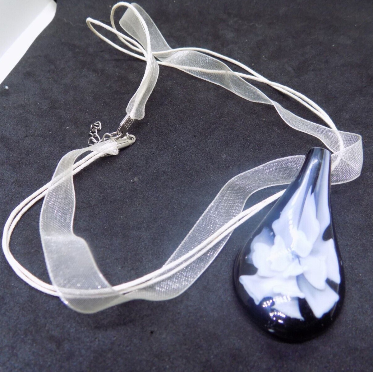 Black and White Petals Glass Pendant on 16″ ribbon & cord silver tone (397)