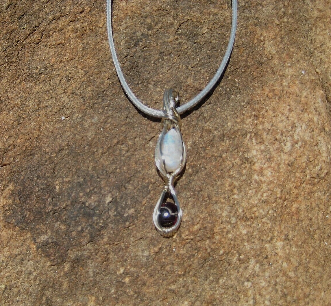 Two small tear drop Stones Rainbow moon stone and a mini round Garnet 925 bail